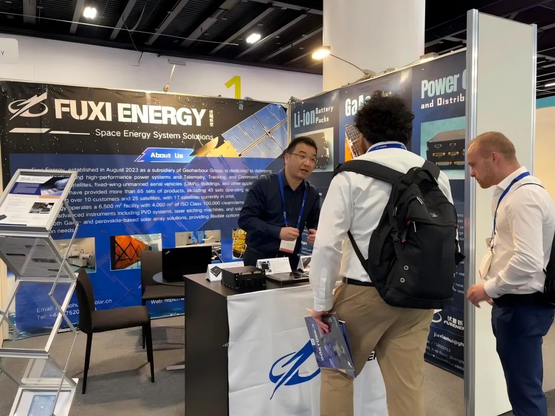 Exhibitor explaining power-system products to visitors at the Fuxi booth.