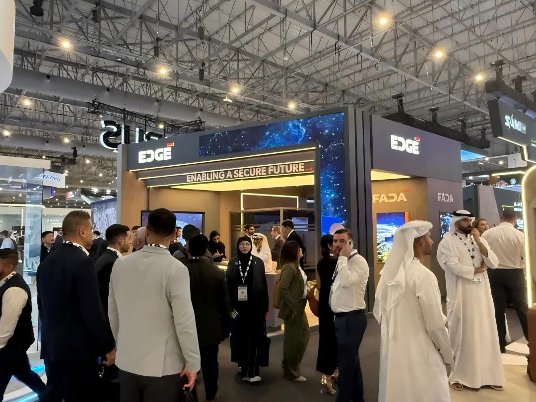 Visitors discussing exhibits at the EDGE trade-show booth.